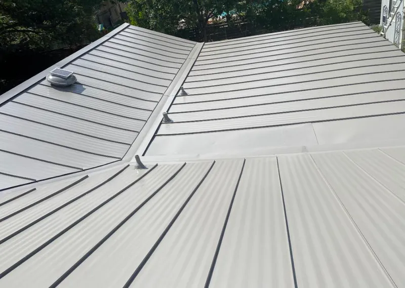 Solar attic fan installed on a metal roof for Roof Ventilation in Sussex
